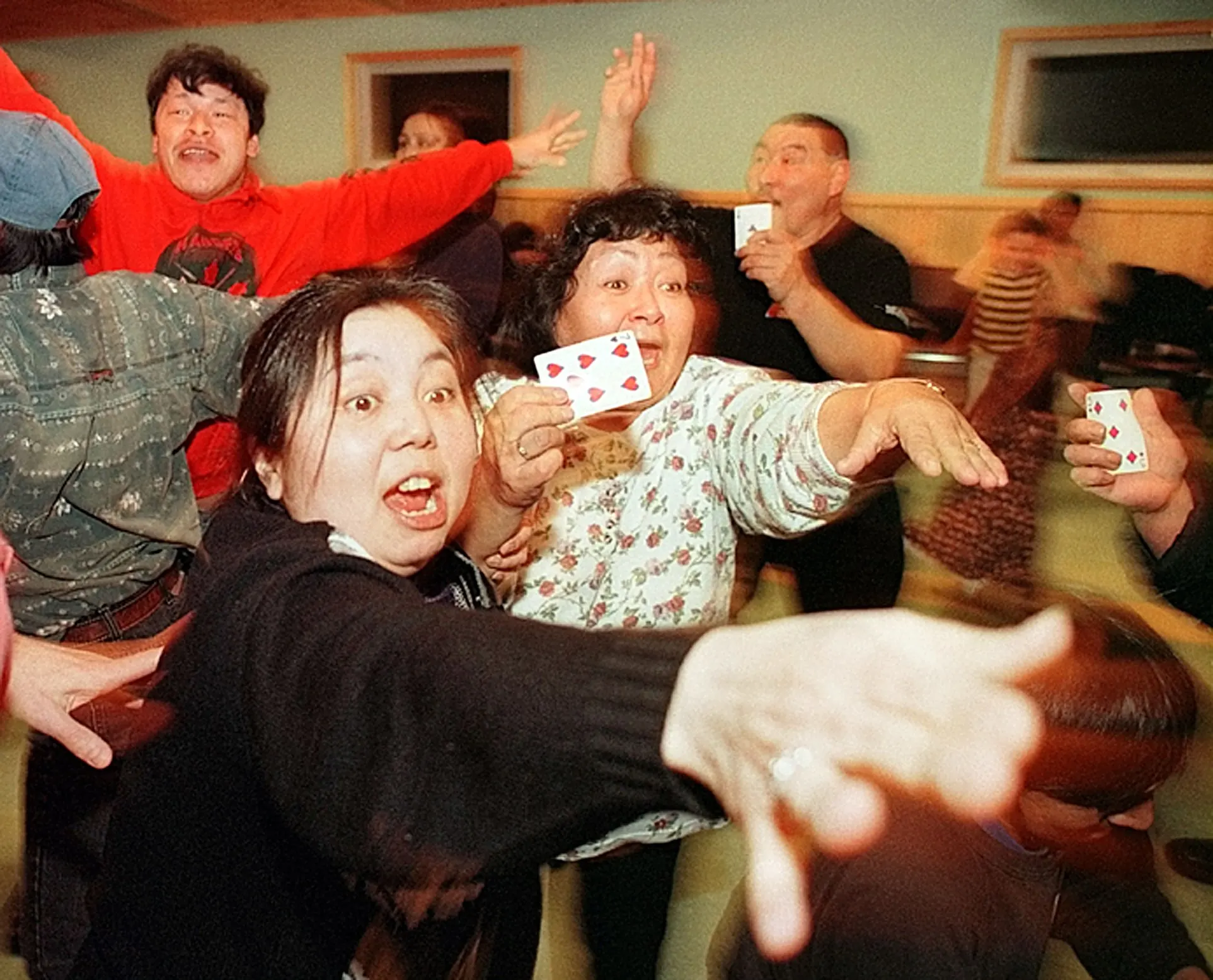 Inuit Social — Playing a energetic version of musical chairs, members of the Inuit community seek out other players who possess the same playing card during a community feast at the St. Jude Anglican Church parish hall in the city of Iqaluit Friday night, February 26, 1999. Located on Baffin Island in the Nunavut Territory of Canada, Iqaluit is the province’s capital city and seat of indigenous Inuit government.  (AP Photo/Stephan Savoia)  © The Associated Press