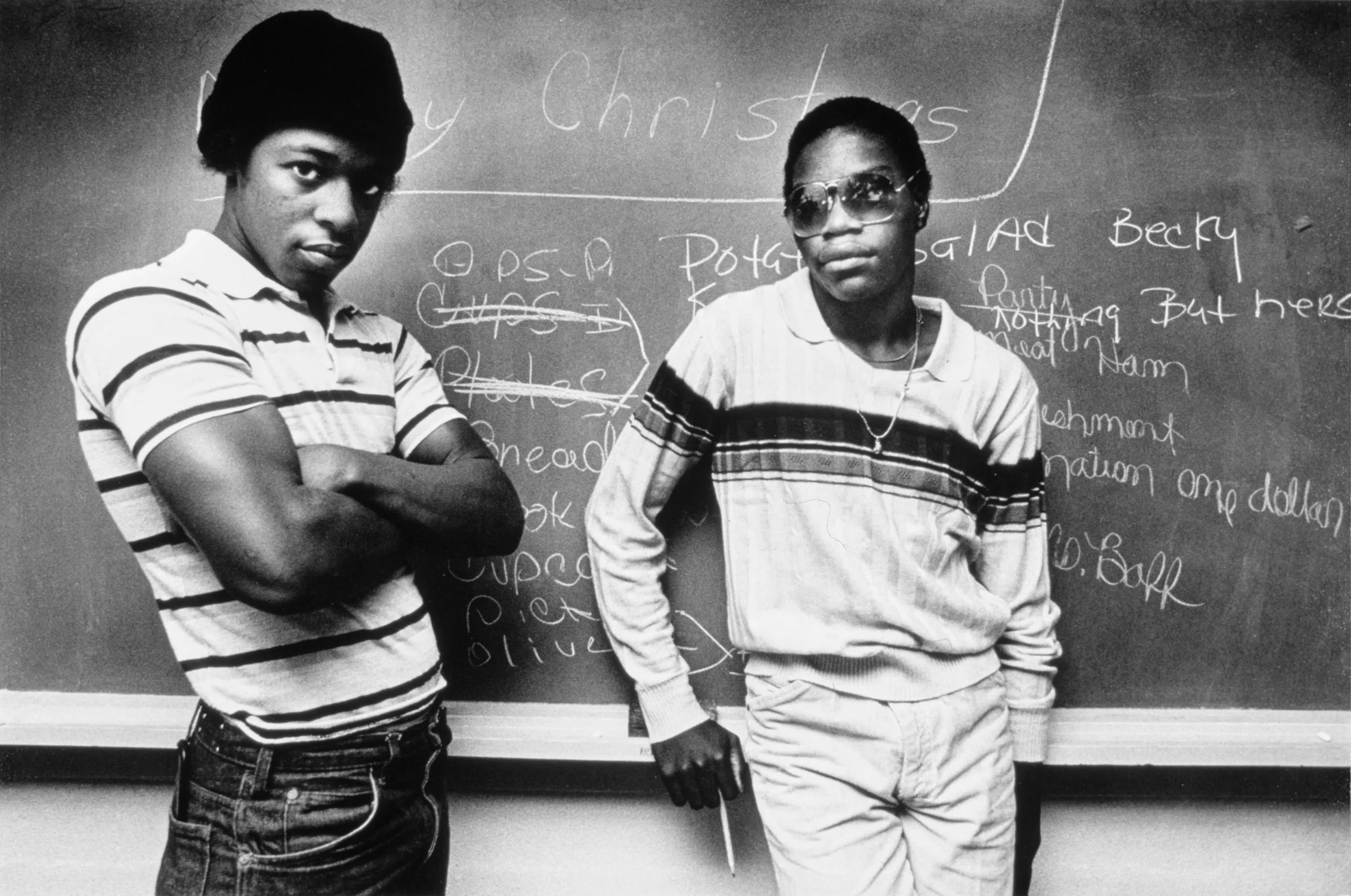 Lost In Educational Segregation — Only a decade after public schools were fully desegregated in Louisiana, a pair of school dropouts working toward their high school equivalency diploma stand in front of a chalkboard at the Monroe Learning Center in Monroe, Louisiana.  (Photo by Stephan Savoia)  Published by The Baton Rouge Louisiana State-Times & Morning Advocate Circa 1980-1984